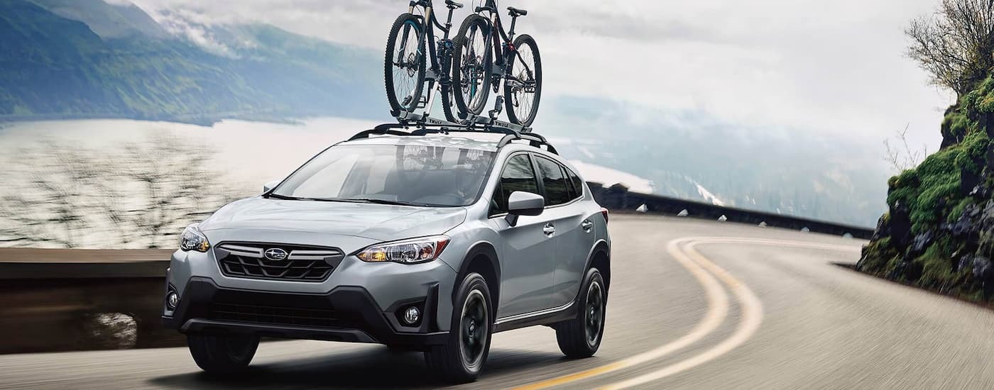 Grey 2022 Subaru Crosstrek driving on a winding road