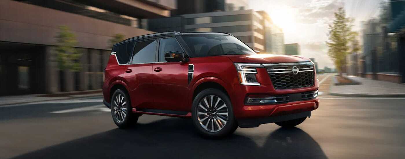 Red 2026 Nissan Armada driving around a bend.