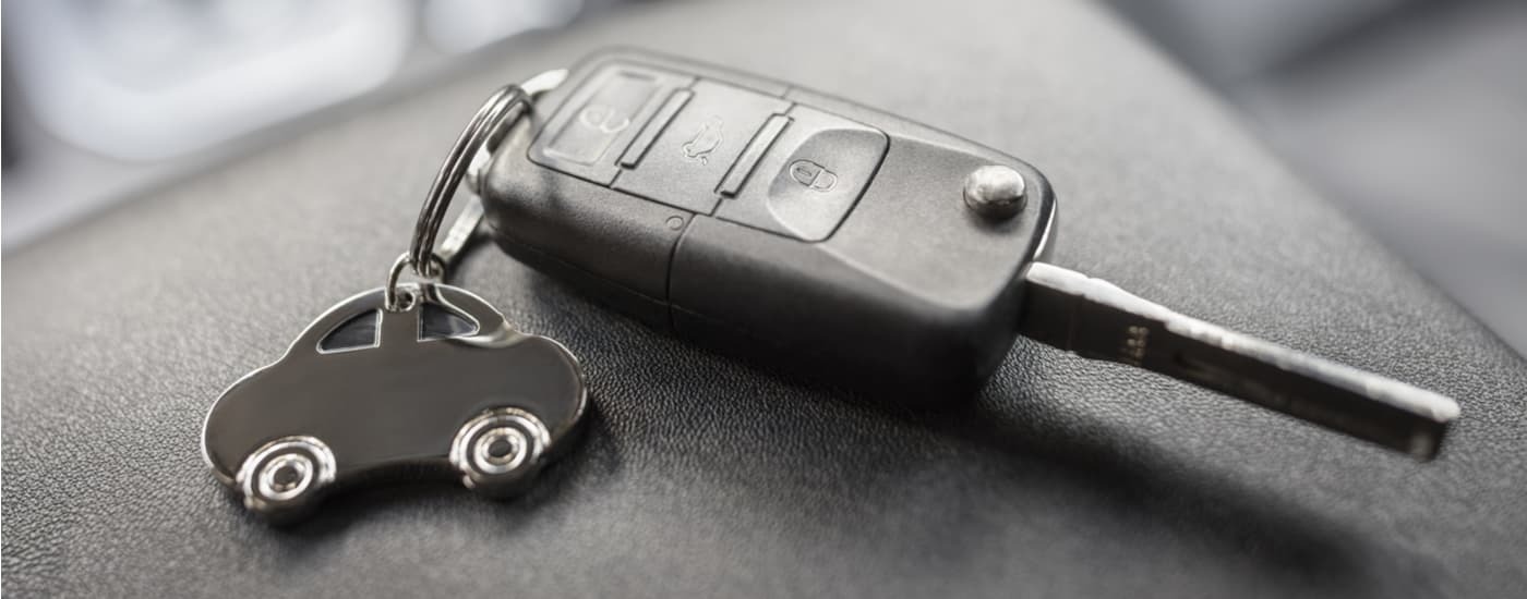 A car key with a small keychain attached to it.