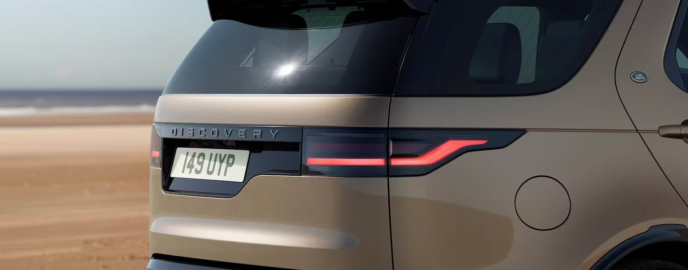 A close up of the rear of a brown 2023 Land Rover Discovery, a popular SUV for sale.