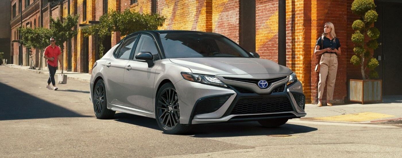 A silver 2022 Toyota Camry XSE Hybrid is shown after visiting a used car dealership.