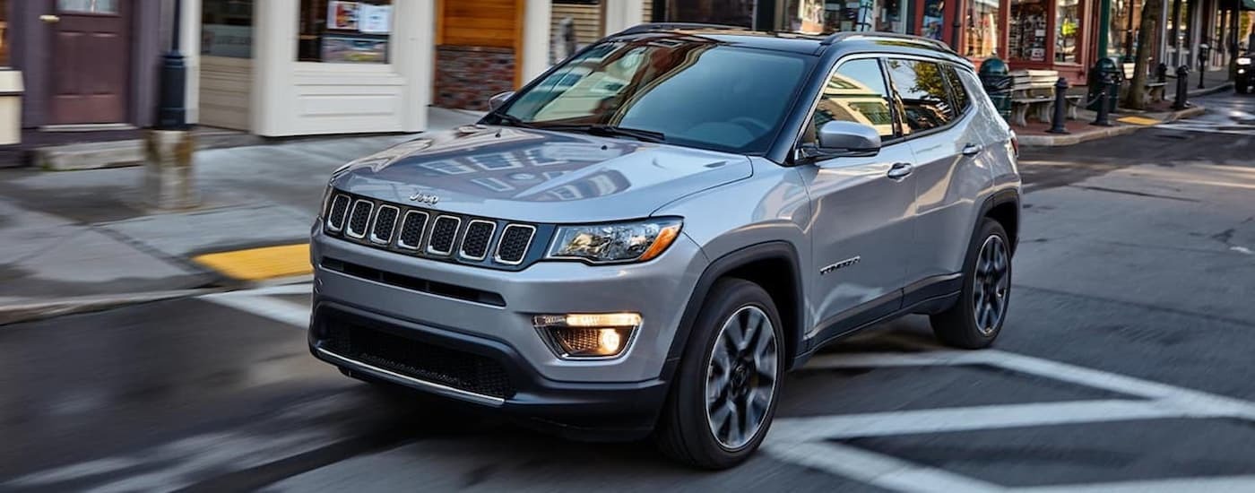 Grey 2020 Jeep Compass, a popular SUV at used car dealers near Staten Island, driving on a city street
