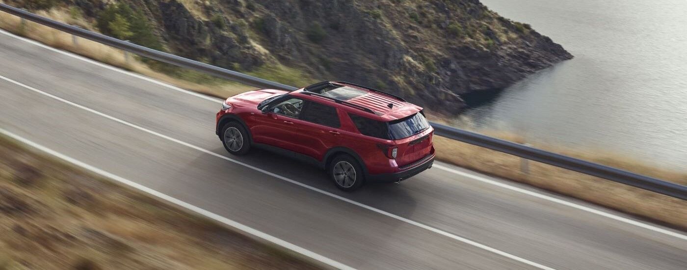 Red 2021 Ford Explorer driving on a mountain road