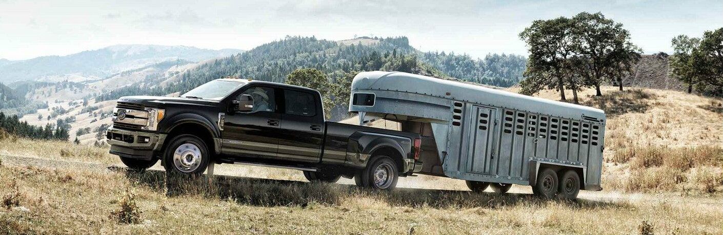 Black 2019 Ford Super Duty F-350 King Ranch towing trailer