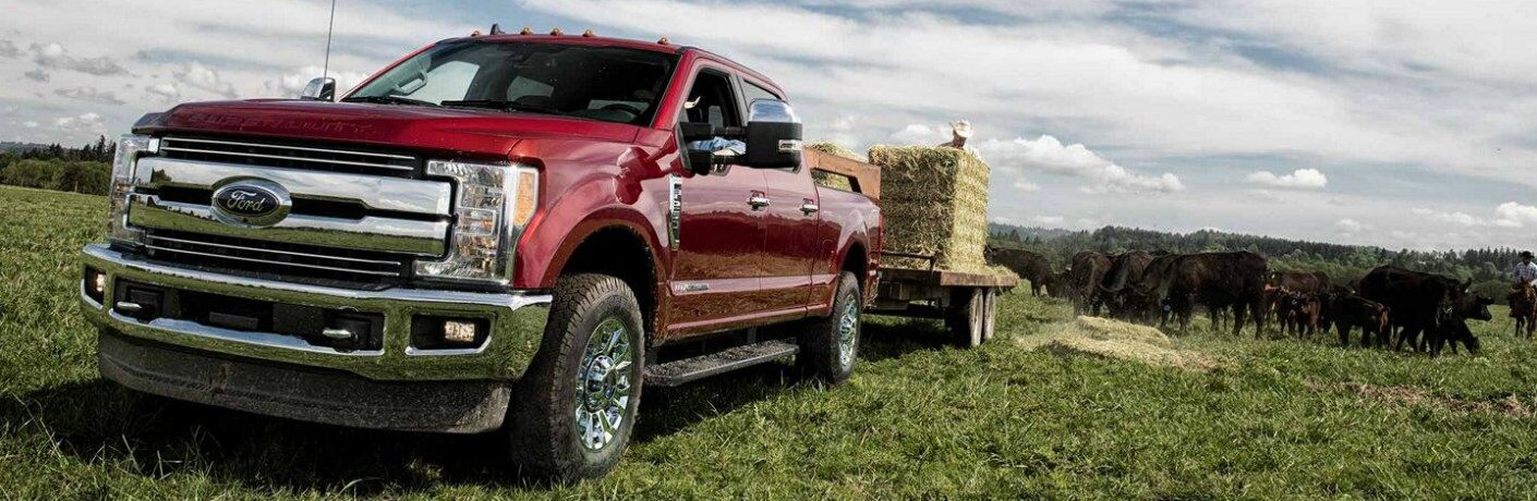 2019 Ford Super Duty F-350 Lariat towing hay bales in field