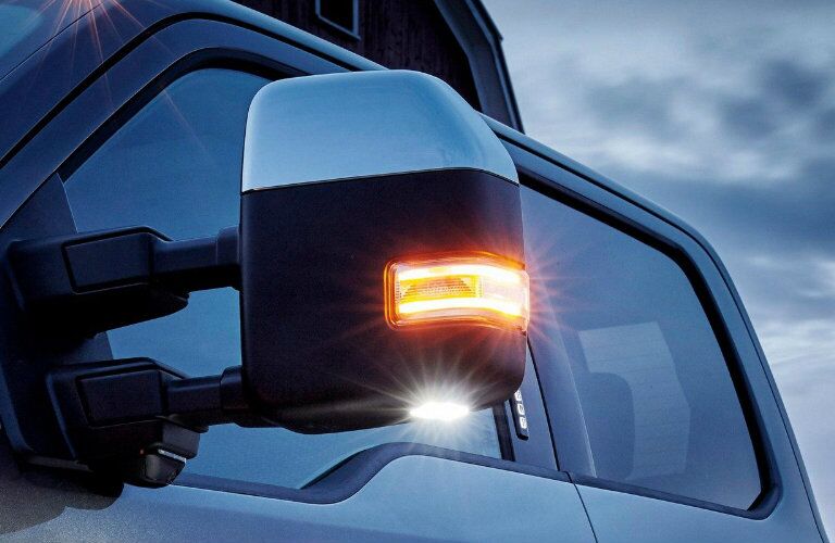 Driver side mirror of blue 2019 Ford Super Duty F-350 Limited