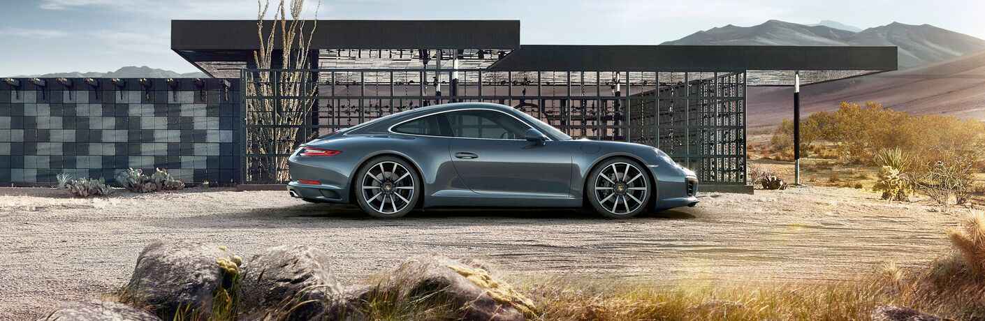 side view of silver porsche 911 carrera