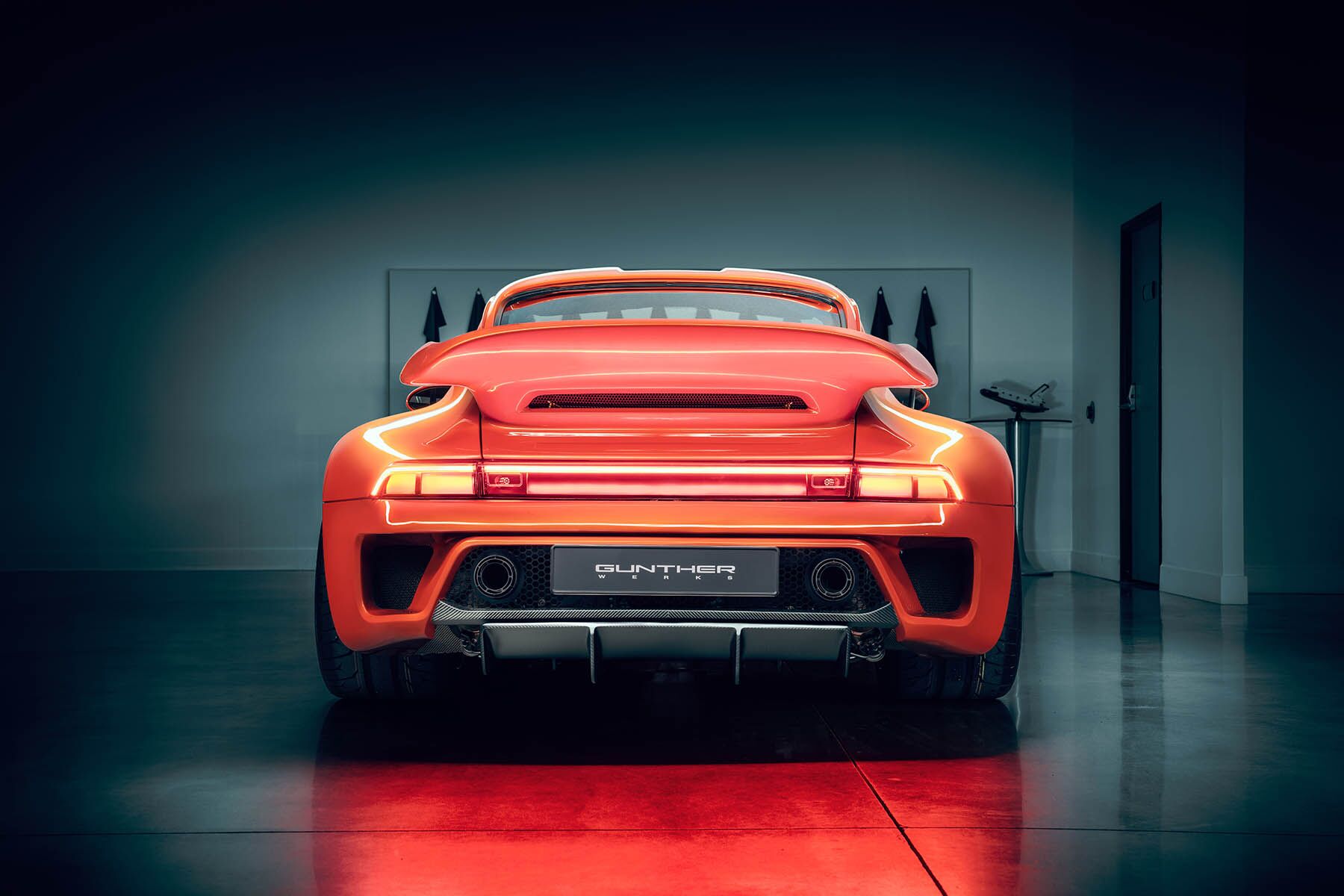 Porsche Turbo model rear view in a dark room
