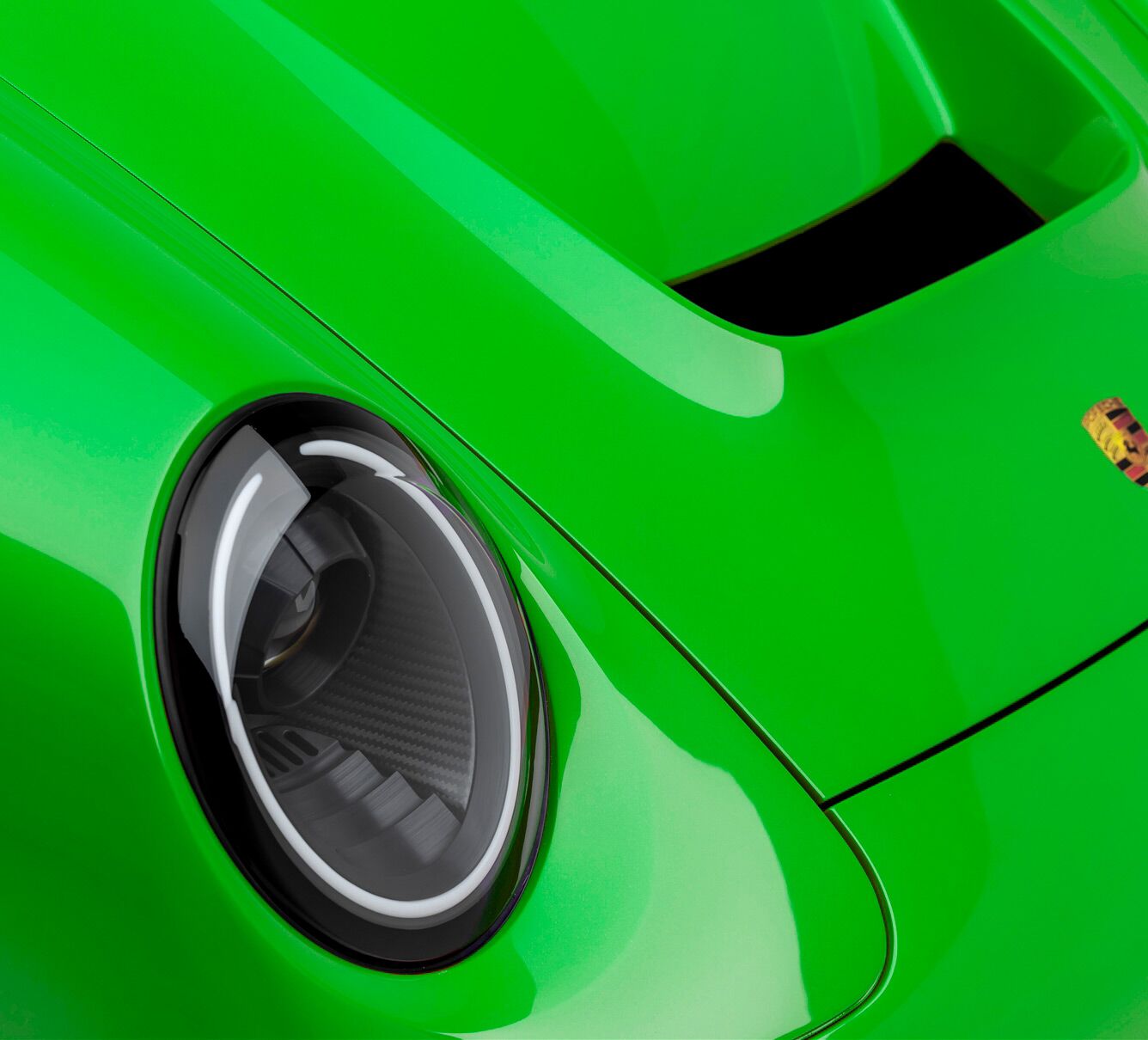 Green paint and headlight of a Porsche Turbo model