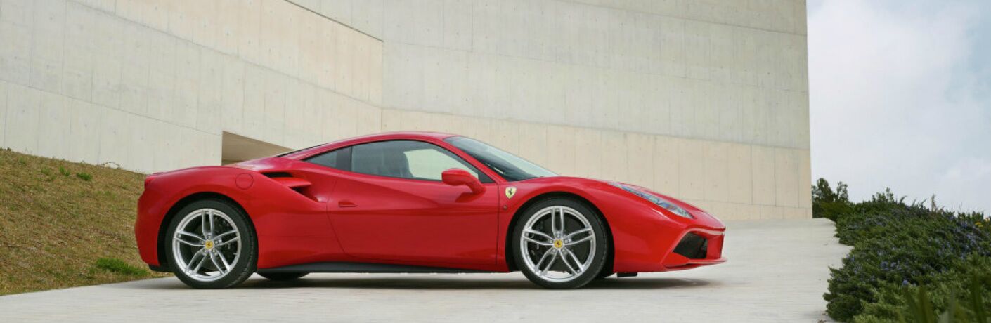 red ferrari 488 parked outside a building