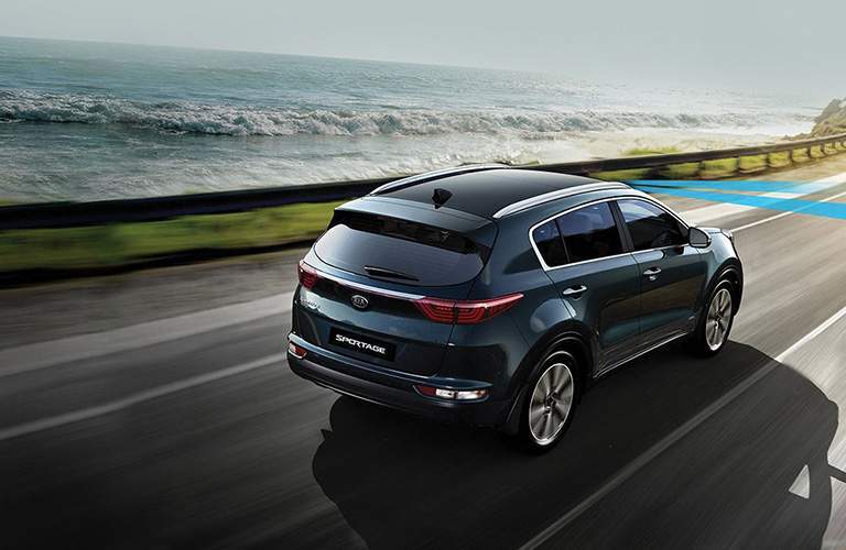 2018 Kia Sportage exterior shot driving on highway near ocean