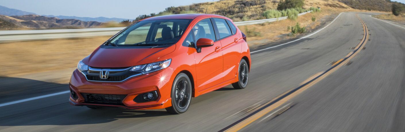 Fury Orange 2019 Honda Fit driving on the road