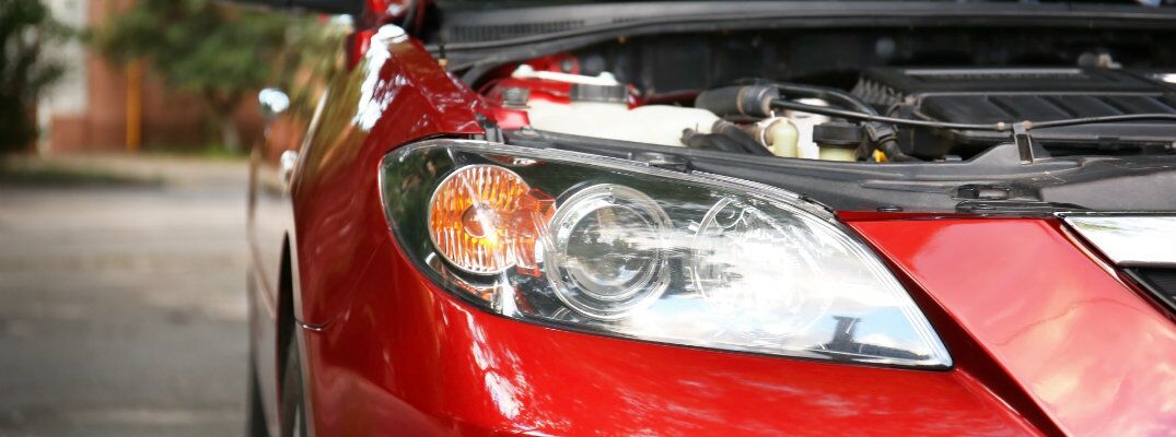 Red car with hood open