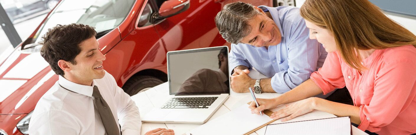 Salesman and couple talking over documents