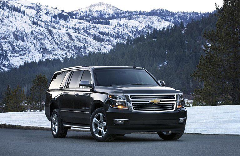 2016 Chevy Suburban in front of a snowy mountain