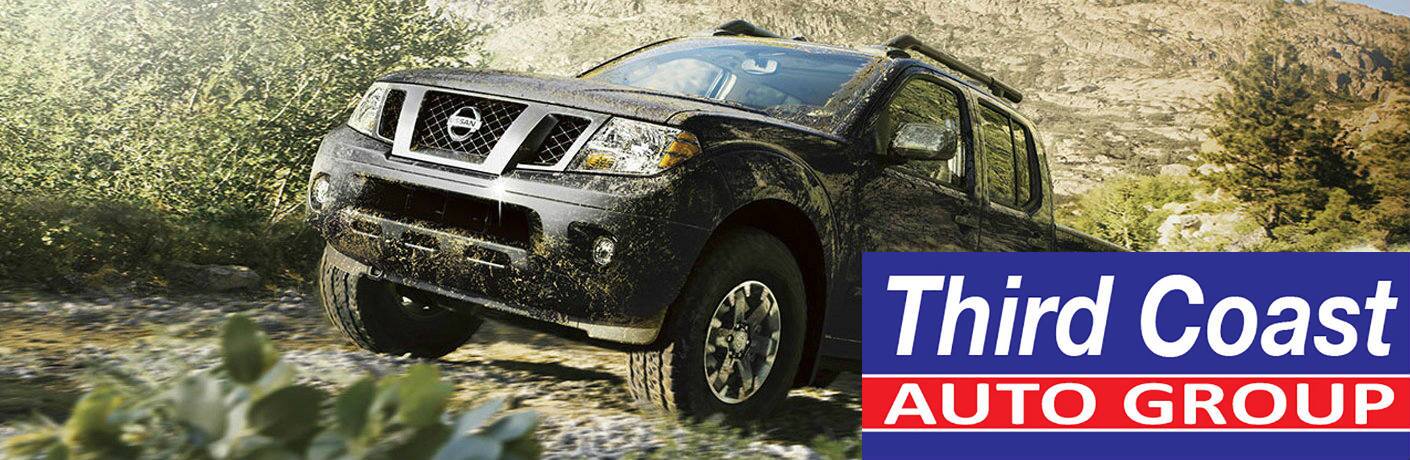 2016 Nissan Frontier with a Third Coast Auto Group logo in the lower right corner