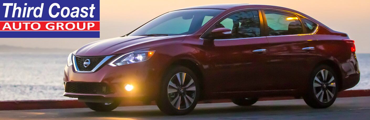 side view of a 2016 Nissan Sentra with a Third Coast Auto Group logo in the corner