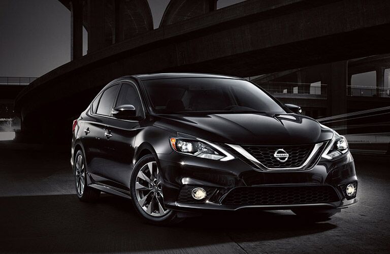 2016 Nissan Sentra in black with a black city background