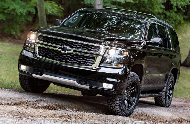 shiny black 2017 Chevy Tahoe with a background of trees