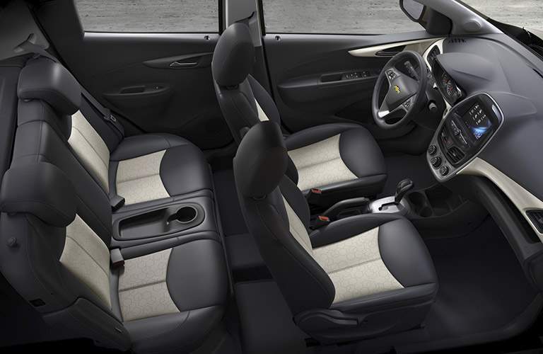 interior of a 2017 Chevy Spark with black and white seating