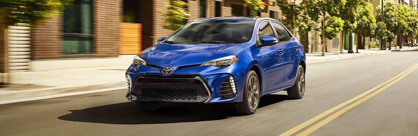 A head-on photo of a used compact sedan for sale near Austin, TX, in this case a Toyota Corolla.