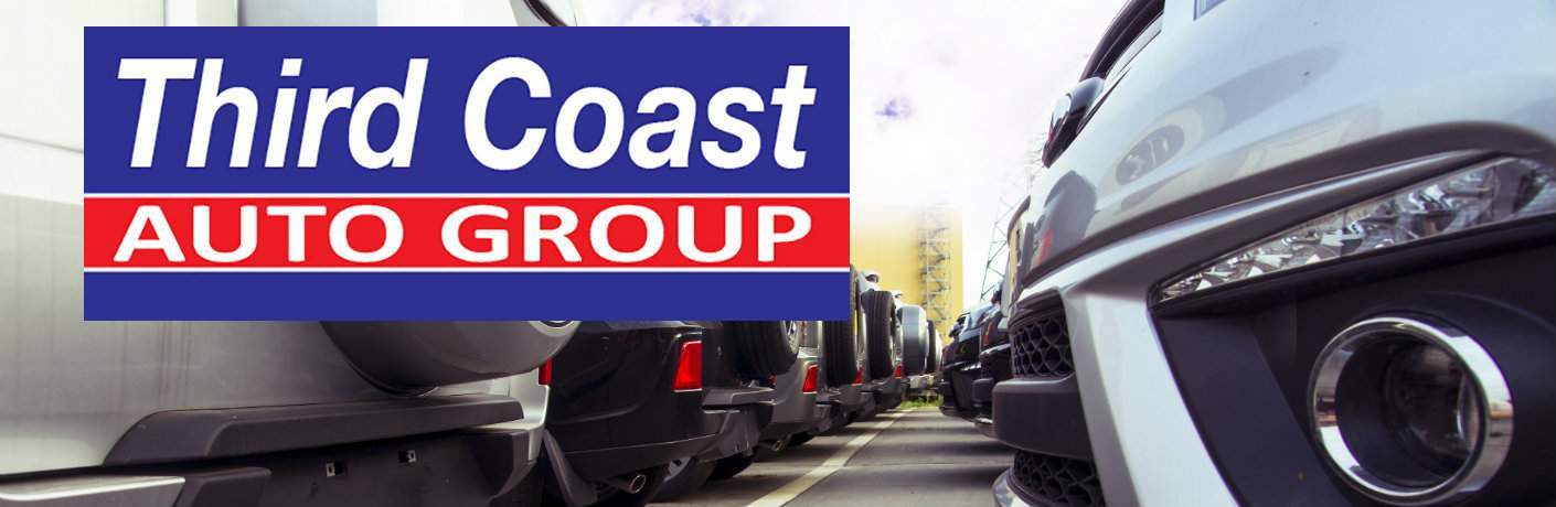Third Coast Auto Group logo imposed over a view of cars at a dealership parked bumper to bumper