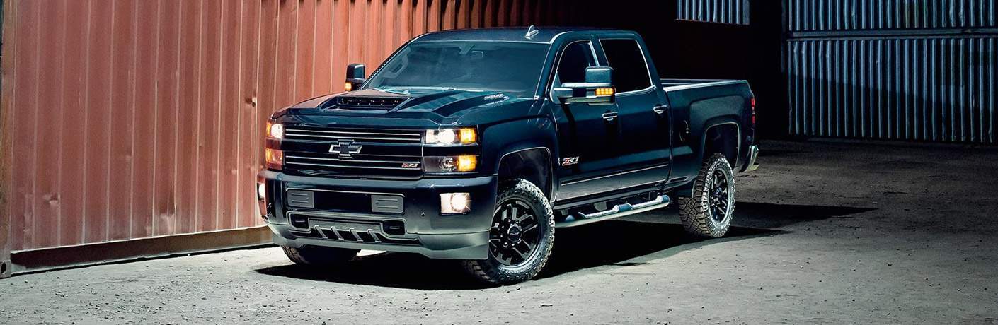 Chevy Silverado 3500HD parked in front of a barn