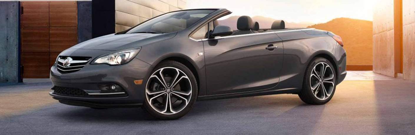 2018 Buick Cascada convertible parked near a building at sunset