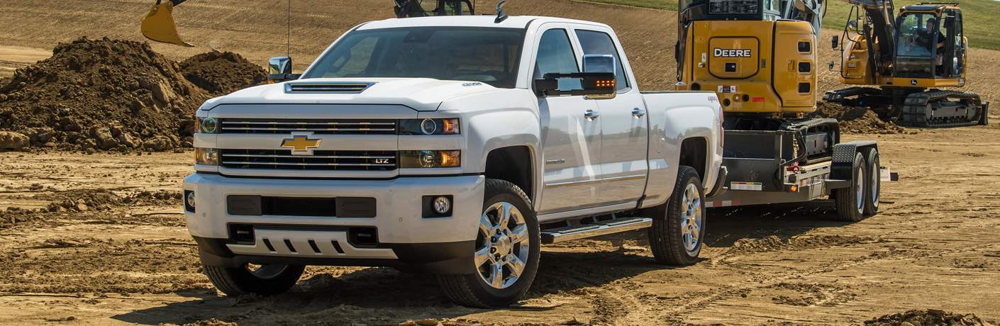 Chevy Silverado 2500HD towing equipment at a job site