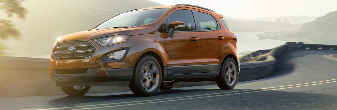 2018 Ford EcoSport in orage driving on a road with ocean views