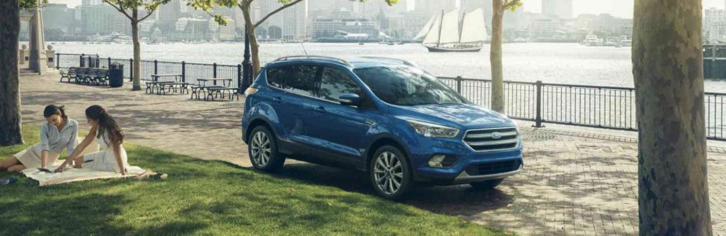 2018 Ford Escape parked next picnickers at the park near water