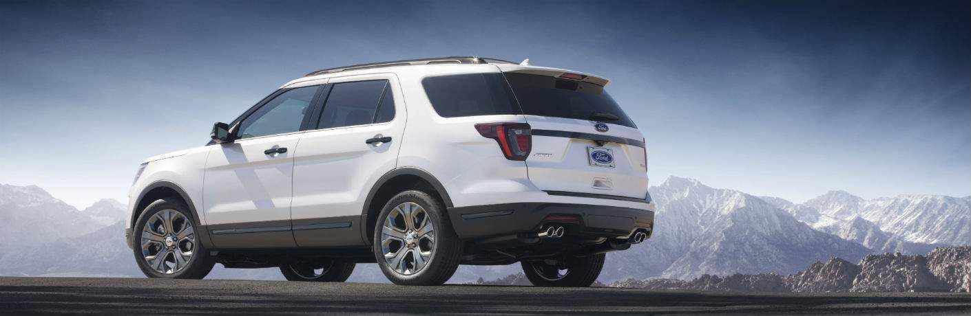 2018 Ford Explorer in white sitting in front of snow-capped mountains