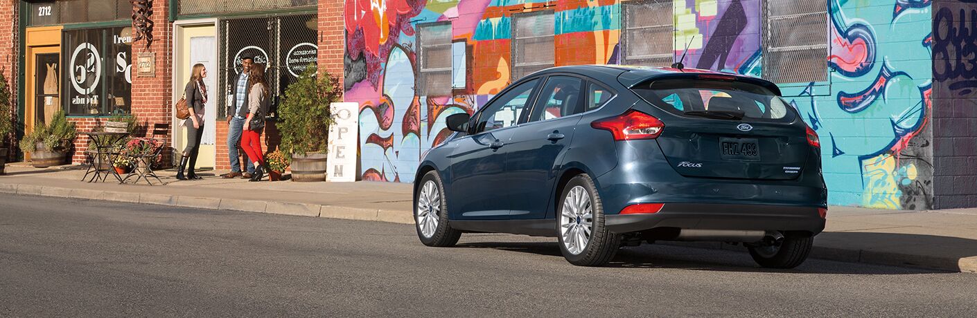 2018 Ford Focus in gray parked in front of a colorful mural