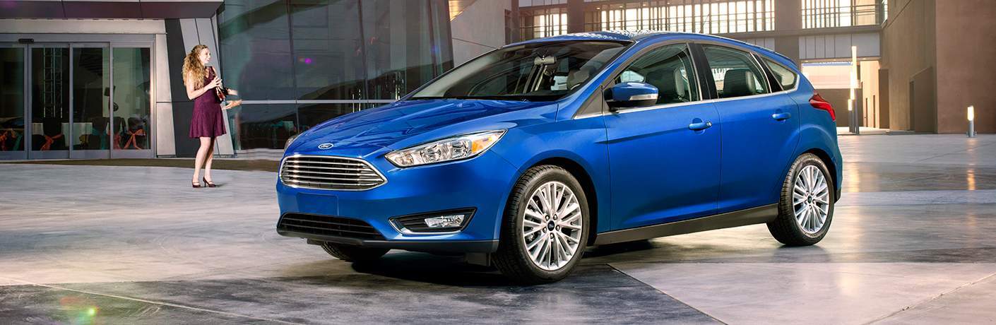 2018 Ford Focus in blue parked in front of a large business