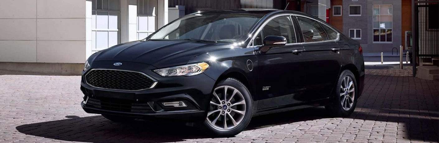 2018 Ford Fusion in black parked on an empty cobblestone street