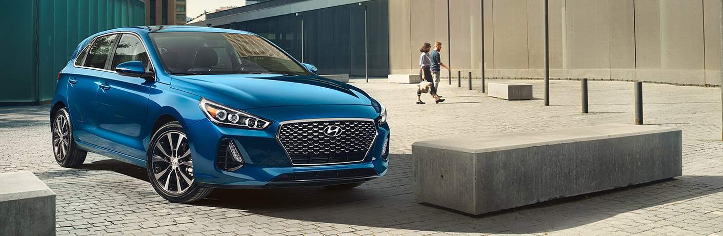 Blue Hyundai Elantra GT parked in a lot in the city