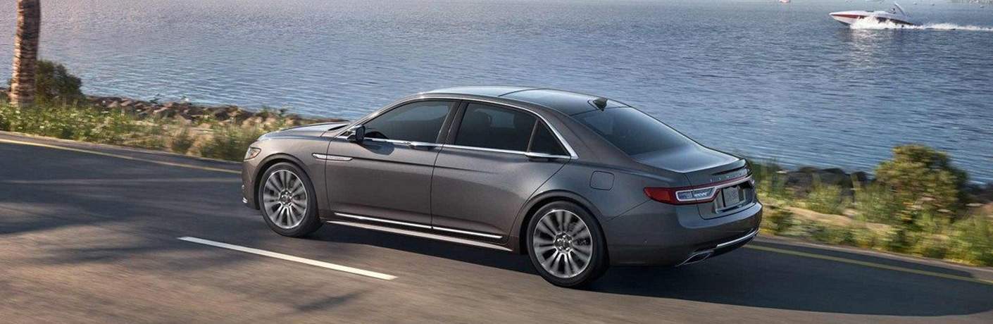 2018 Lincoln Continental in grey driving along a waterfront road