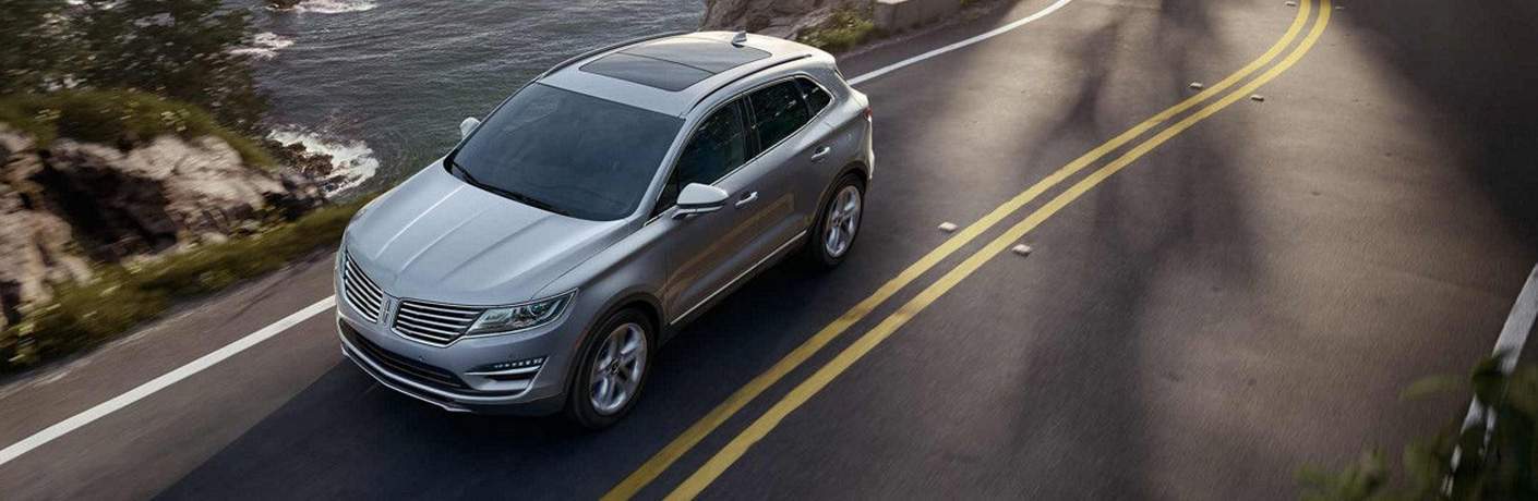 Overhead shot of the 2018 Lincoln MKC in grey driving down a country road