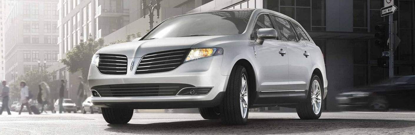 2018 Lincoln MKZ parked in the middle of a busy city street with pedestrians