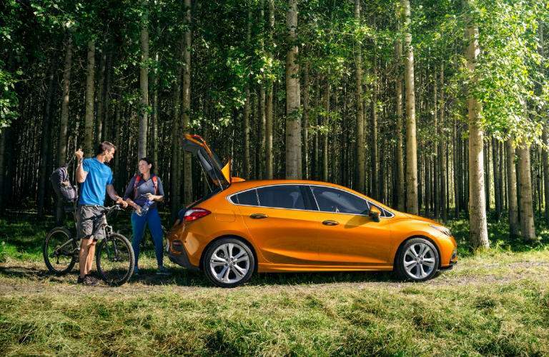 2018 Chevy Cruze in orange parked in the woods