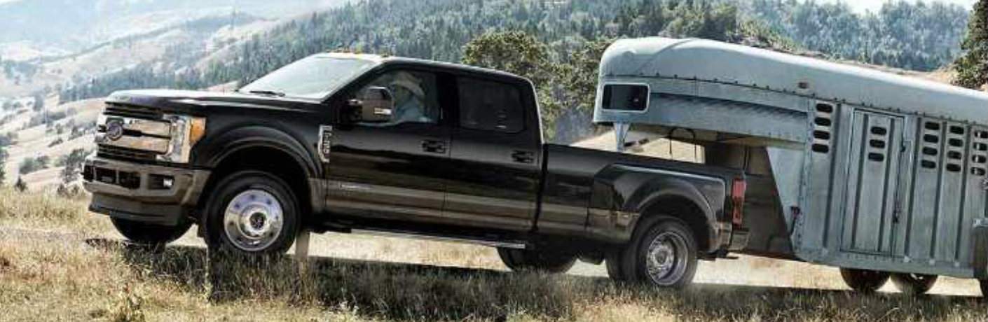 2018 Ford F-350  hauling a silver trailer up a mountain