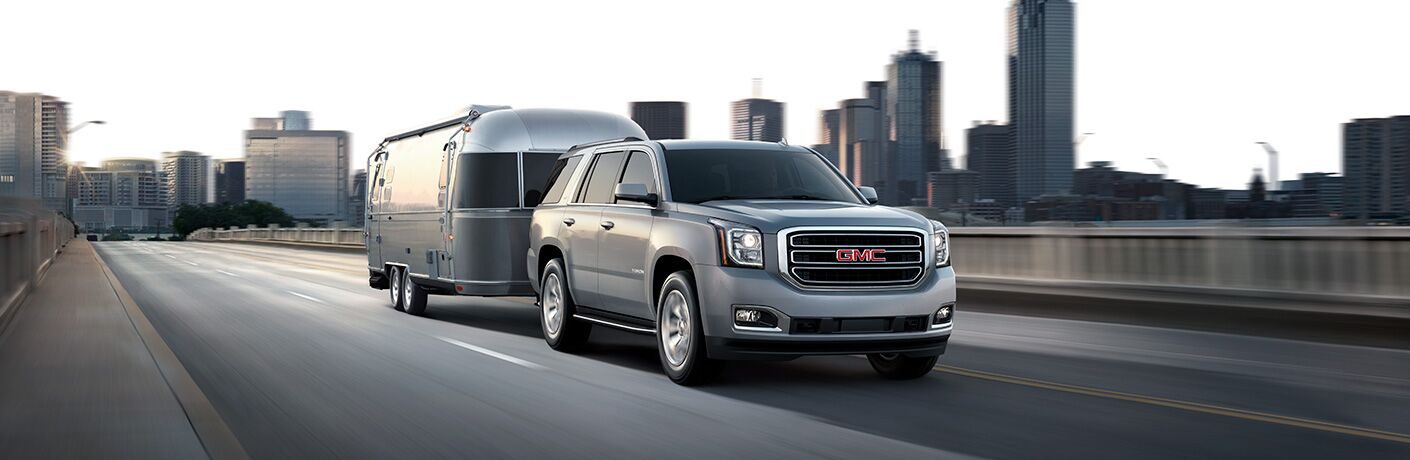 2019 GMC Yukon hauling an airstream on a city highway