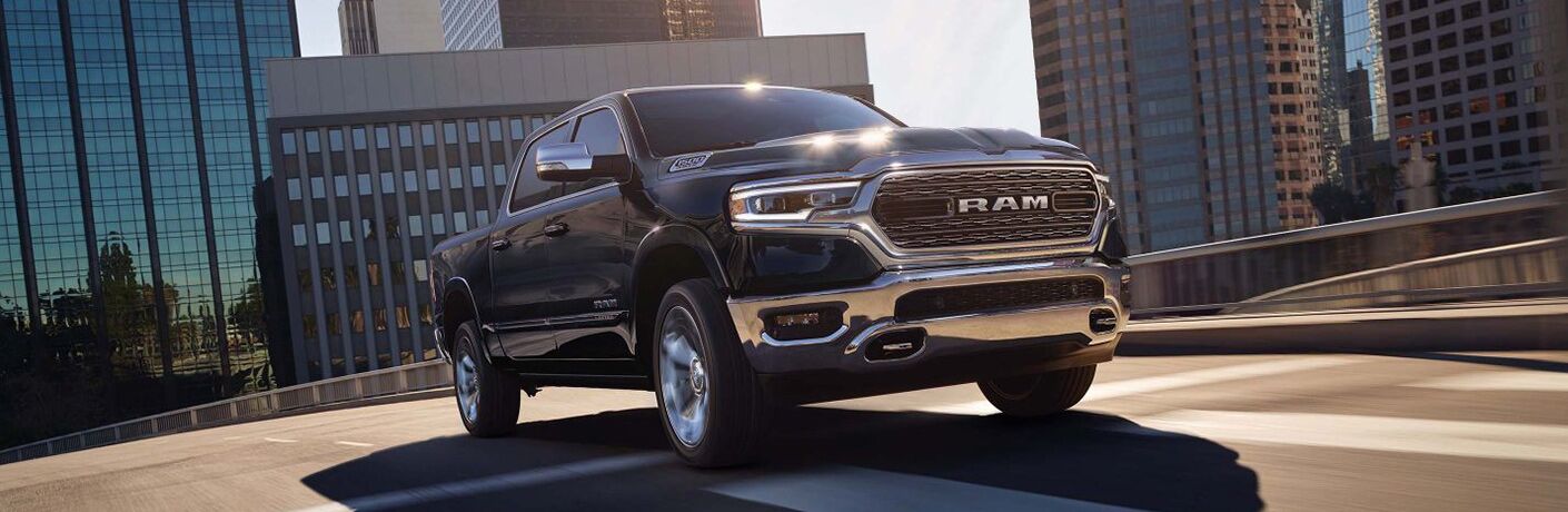 2019 Ram 1500 driving on an empty highway in a big city