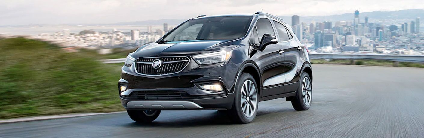 2020 Buick Encore driving past a big city