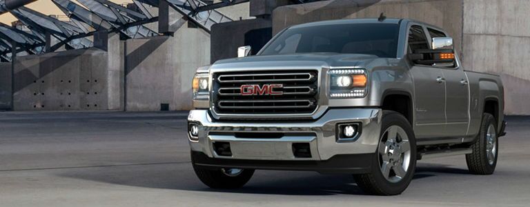GMC Sierra 2500HD parked in front of a concrete building