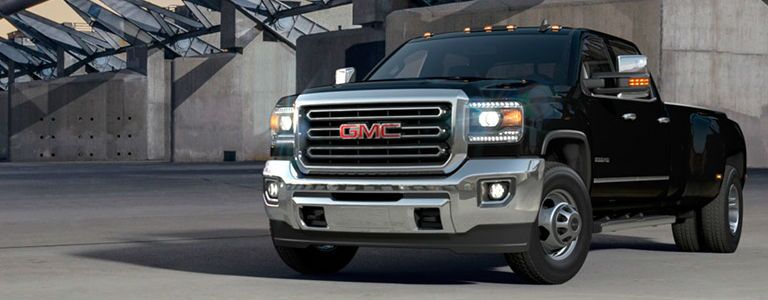 GMC Sierra 3500HD parked in front of a concrete structure
