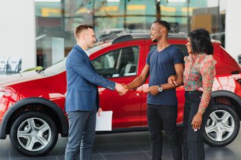 couple buying a car in a dealership