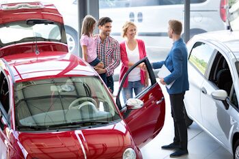 family buying a car inside of a dealership