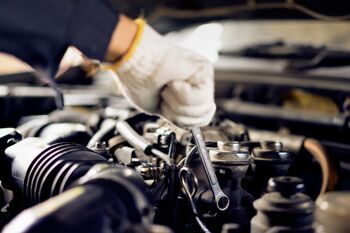 mechanic working on a car engine