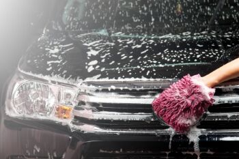 car being hand-washed with a microfibre mitt